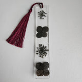 Handcrafted resin bookmark with real black dried flowers and tassel by Blue Bourbon Designs