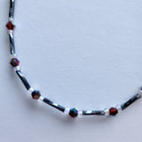 Handmade black and red iridescent glass bead ankle bracelet by Blue Bourbon Designs