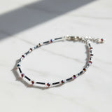 Handmade black and red iridescent glass bead ankle bracelet by Blue Bourbon Designs