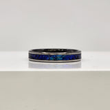Hand-turned dichroic resin ring on a 2mm stainless steel band shifting blue and green in the light