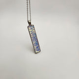 Caribbean dichroic pendant with iridescent Dichrolam resin on stainless steel chain.