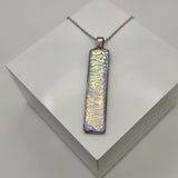 Caribbean dichroic pendant with iridescent Dichrolam resin on stainless steel chain.