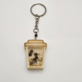 Coffee shaker keychain filled with oil and floating charms