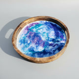 Round resin serving tray with metal handles and non-slip pads