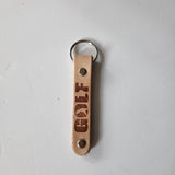 Laser-engraved leather key fob keychain with detailed design.