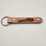 Laser-engraved leather key fob keychain with detailed design.