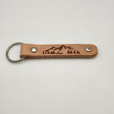 Laser-engraved leather key fob keychain with detailed design.