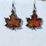 Maple leaf earrings made from laser cut wood and hand-poured resin with brass hooks