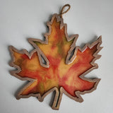 Handmade wooden maple leaf filled with resin in fall colors by Blue Bourbon Designs