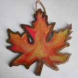Handmade wooden maple leaf filled with resin in fall colors by Blue Bourbon Designs