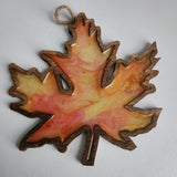 Handmade wooden maple leaf filled with resin in fall colors by Blue Bourbon Designs