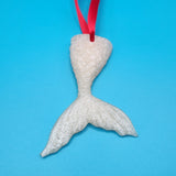 Hand-poured resin mermaid tail ornament in multiple colors.