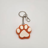 Hand-poured resin pawprint keychain supporting animal rescue