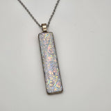 Pearl dragon burl dichroic pendant with iridescent Dichrolam resin on stainless steel chain.