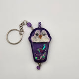 Penguin drink shaker keychain filled with oil and floating charms.