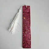 Handmade pink glitter resin bookmark with white tassel by Blue Bourbon Designs.