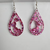 Teardrop resin earrings with heart accents in multiple colors by Blue Bourbon Designs