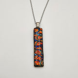 Red burl dichroic pendant with iridescent Dichrolam resin on stainless steel chain