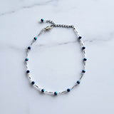 Adjustable blue and white beaded anklet with a silver tube beans and adjustable chain.