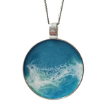 2-inch round ocean resin necklace with waves on a stainless steel chain