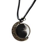 Reversible crescent moon pendant with two unique resin sides.