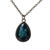 Teardrop alcohol ink resin pendant with domed finish on stainless steel chain.